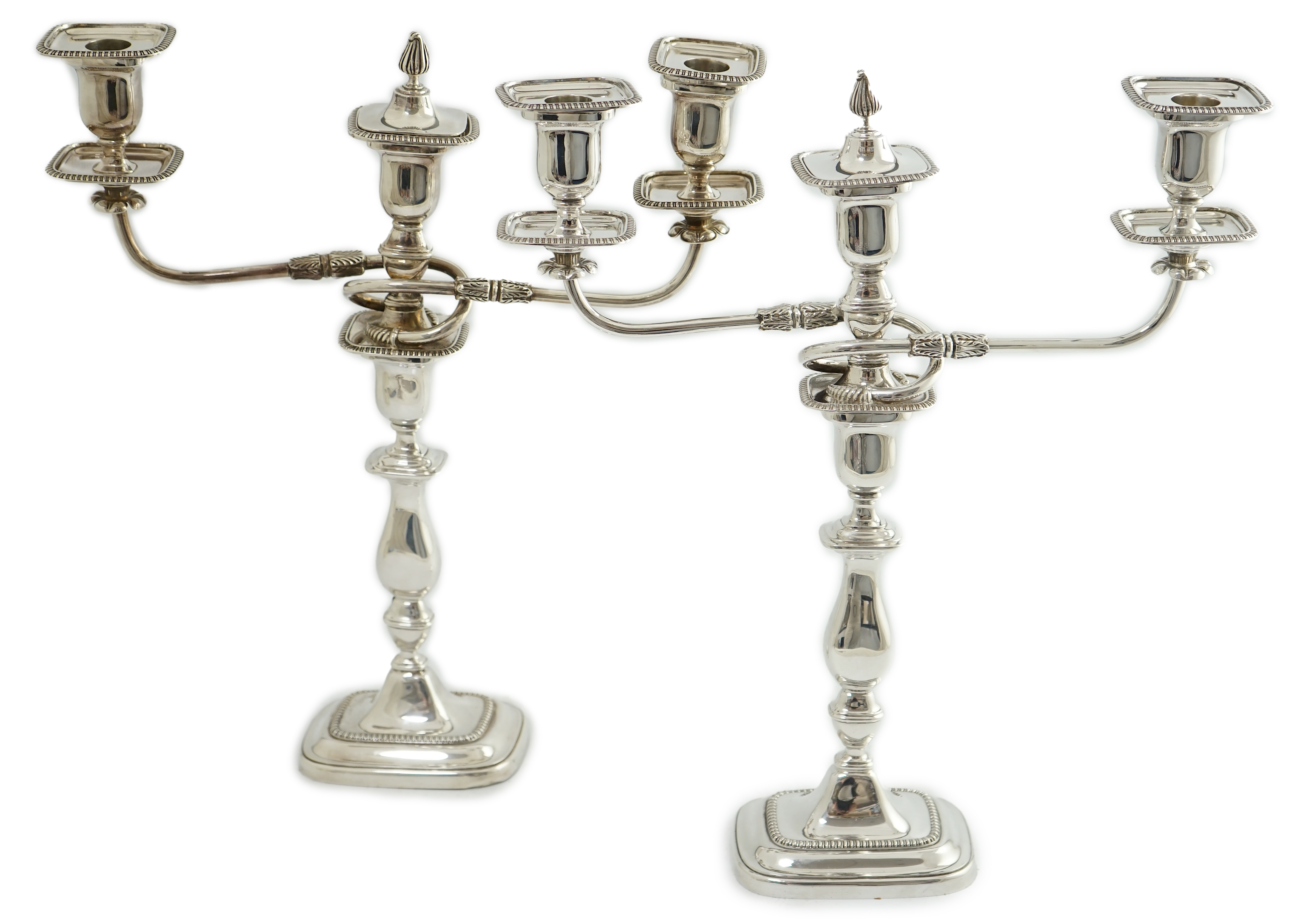 A pair of Elizabeth II silver two branch two light candelabra, by James Dixon & Sons